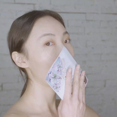 Video of a woman using the Snow Fox Skincare Hot Stone Brightening Sheet Mask, massaging her face with a gua sha while using the mask.